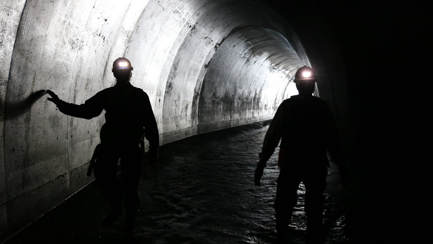 MWMO monitoring team staff inspecting a stormtunnel near downtown Minneapolis.