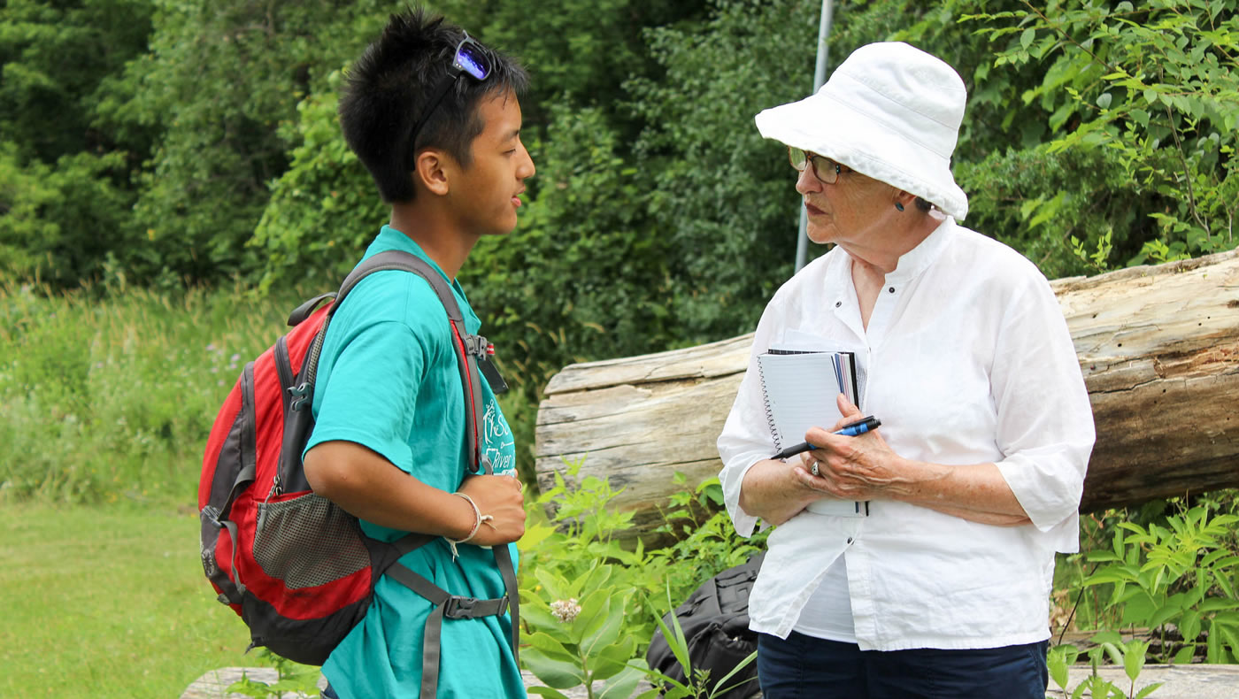 Ruth visiting with a Mississippi River Green Team member in the field.