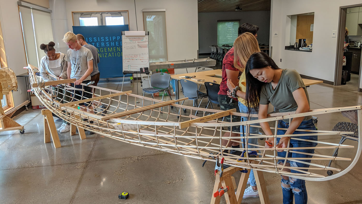 Mississippi River Green Team members working on the Urban Boatbuilders canoe.