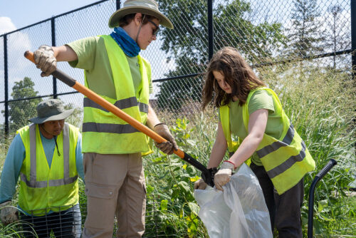 Green Infrastructure Inspection (GrIIT) youths are removing contaminated soil into a trash bag